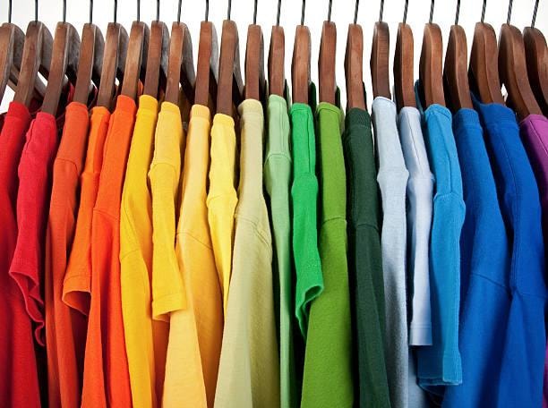 Colorful clothing on a rack representing professional organizing